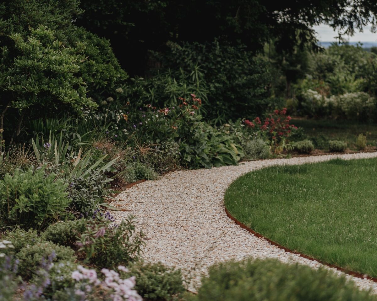 Gravel path sweeping between mixed planting and the circular lawn, Over Stowey