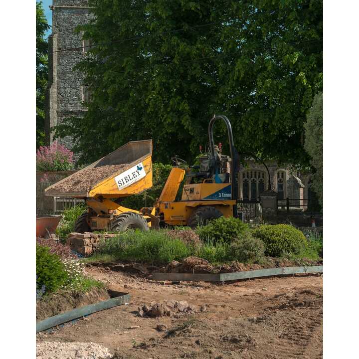 Sibley Landscapes dumper tipping material next to the part-built circular bed