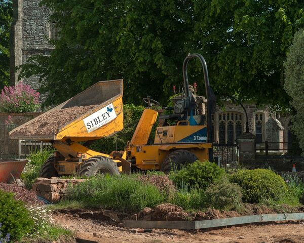 Sibley Landscapes dumper tipping material next to the part-built circular bed