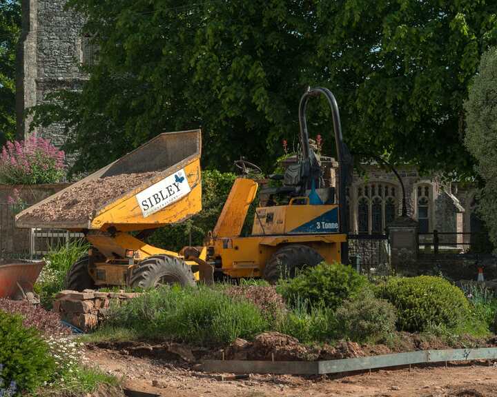 Sibley Landscapes dumper tipping material next to the part-built circular bed