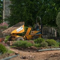 Sibley Landscapes dumper tipping material next to the part-built circular bed