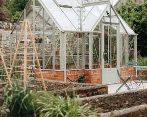 Finished heritage-style greenhouse on its red brick base in the walled garden, Chard