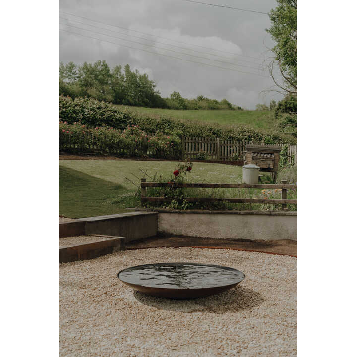 Water feature and gravel terrace on a sloping garden, Weare, Axbridge