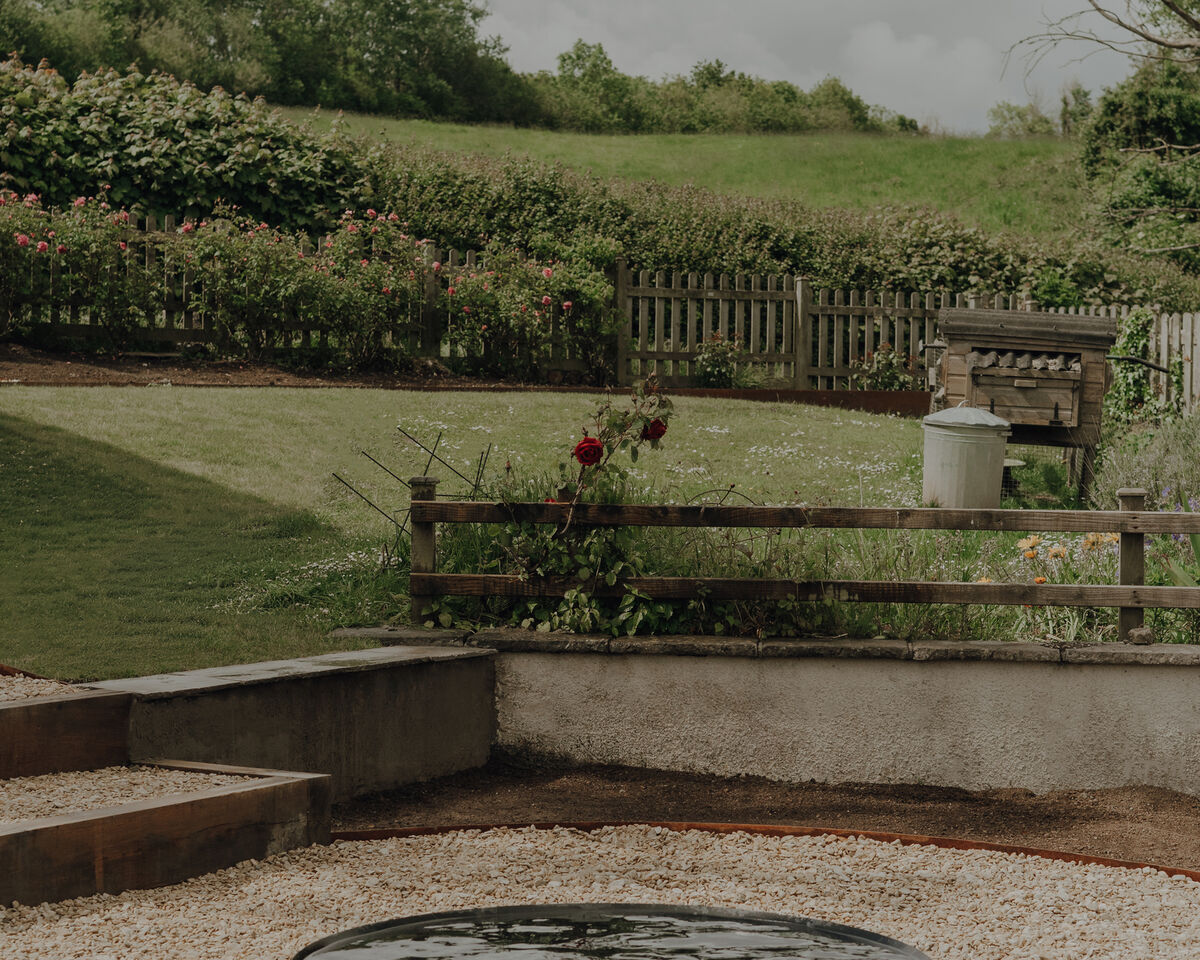 Water feature and gravel terrace on a sloping garden, Weare, Axbridge