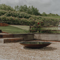 Planting border and seating area, sloping garden, Weare, Axbridge