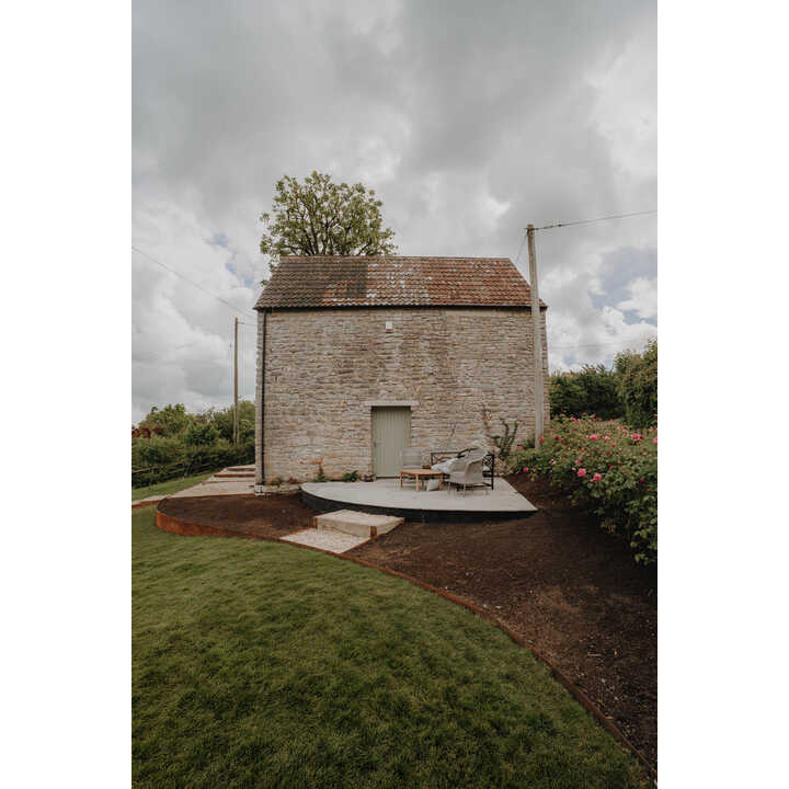 Stone outbuilding with new lawn and terracing, sloping garden, Axbridge