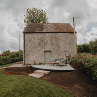 Stone outbuilding with new lawn and terracing, sloping garden, Axbridge