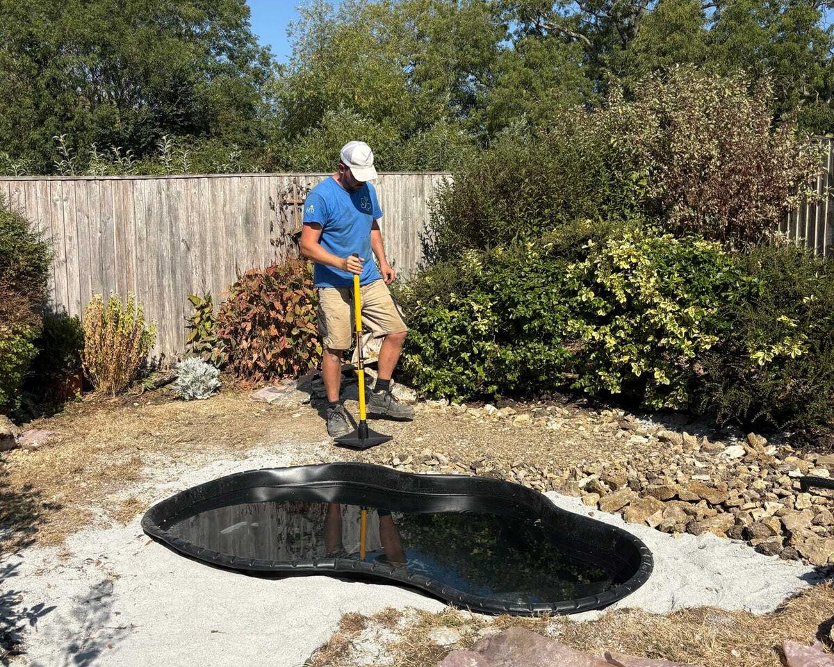 New pond liner installed in the excavated area during the build