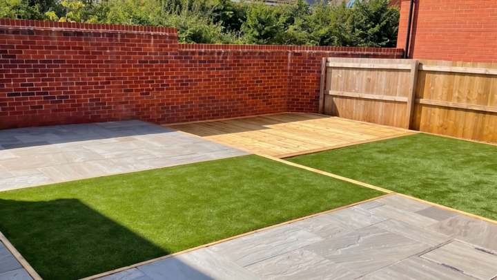 A glass greenhouse with plants, adjacent to a stone path and house, under a cloudy sky.